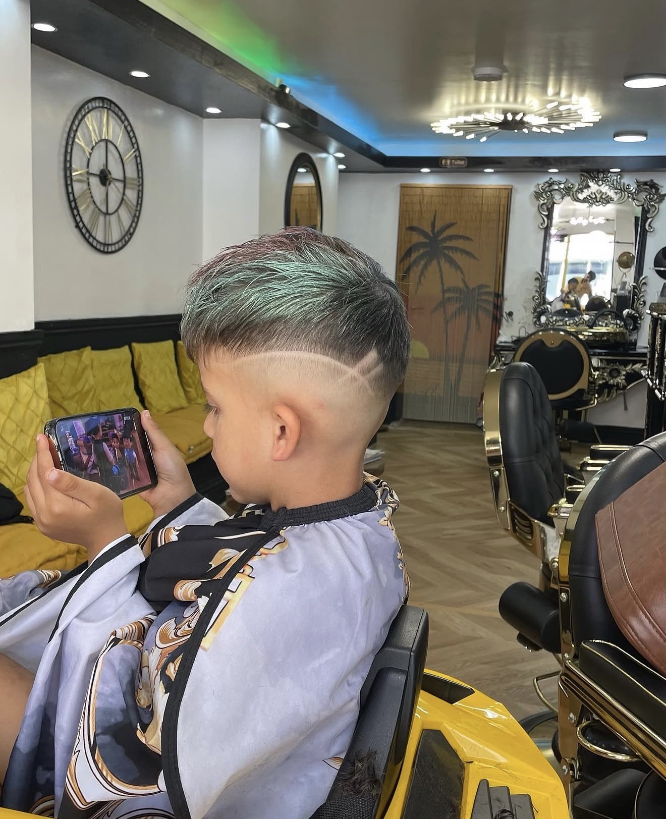 Child's skin fade with a green-toned top and crisp side design
