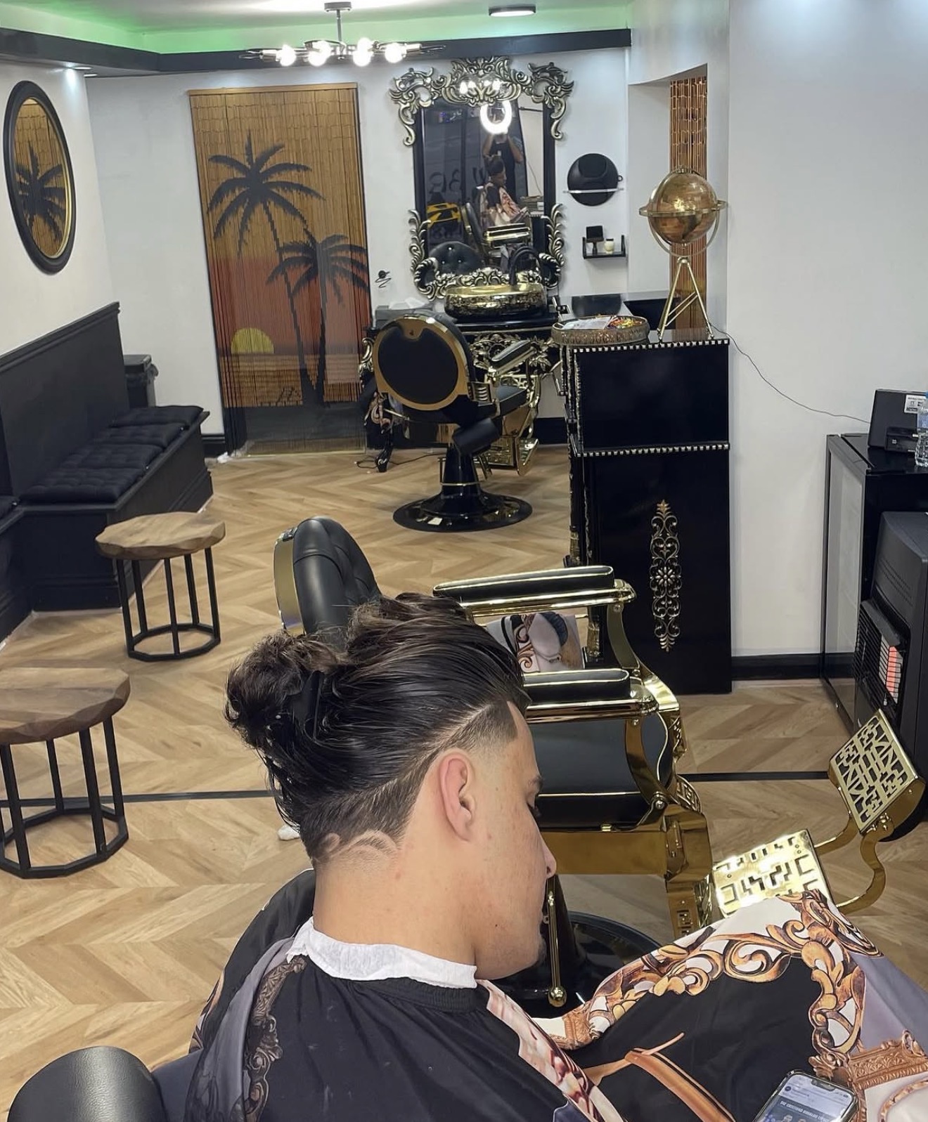 Long-top fade with a precision hair design, set in the Barber 1 interior